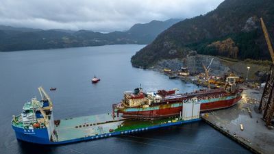 A decommissioned ship is brought ashore at Vats, near Haugesund, to be cleaned so that the steel can be reused in buildings.